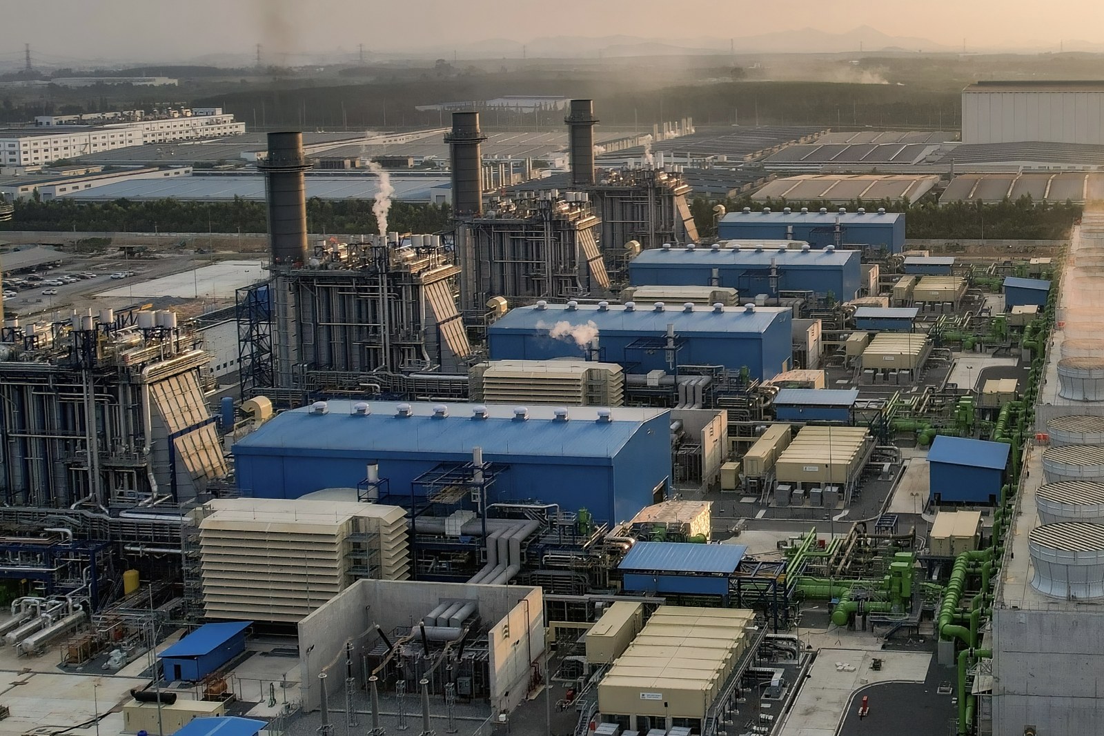 Data center campus with on-site gas turbine generators at sunset